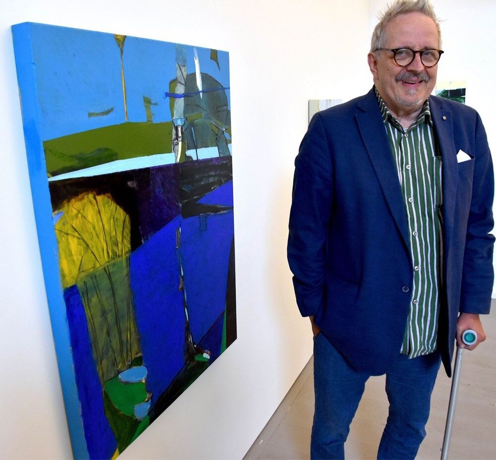 Anders Waernebo Garnow standing beside a large blue painting