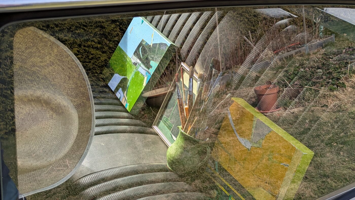 A hat and a painting inside the car
