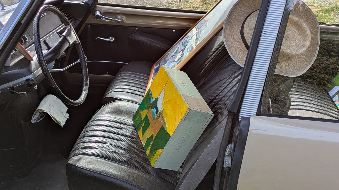 Interior of the Citroën DS with paintings and a hat
