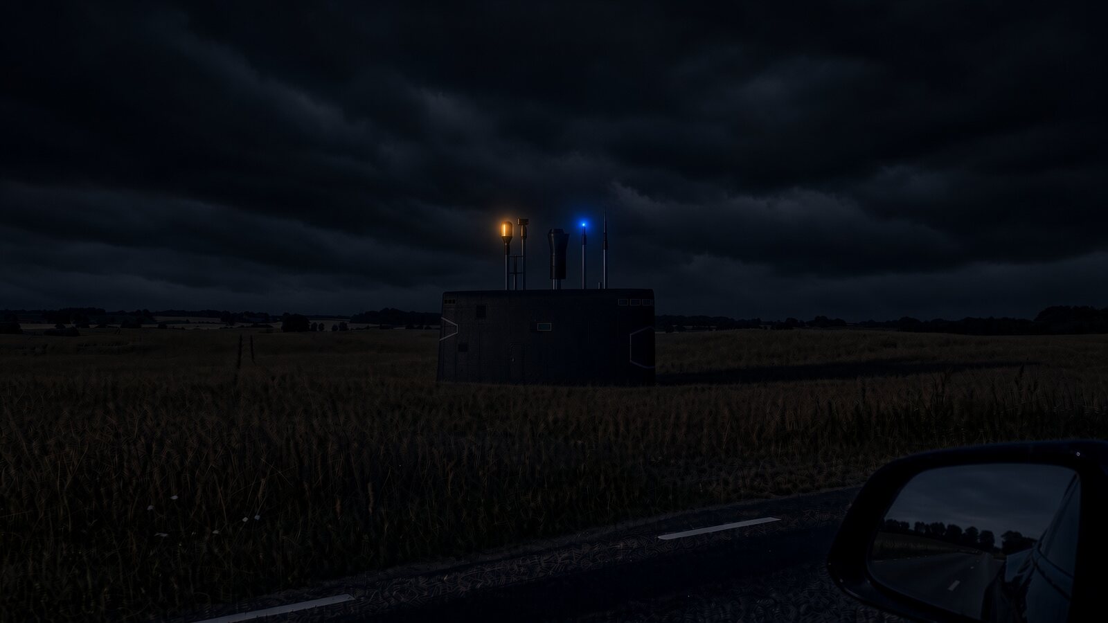 Mockup of the submarine tower in a field at night, two lights on the antennas, seen from a road